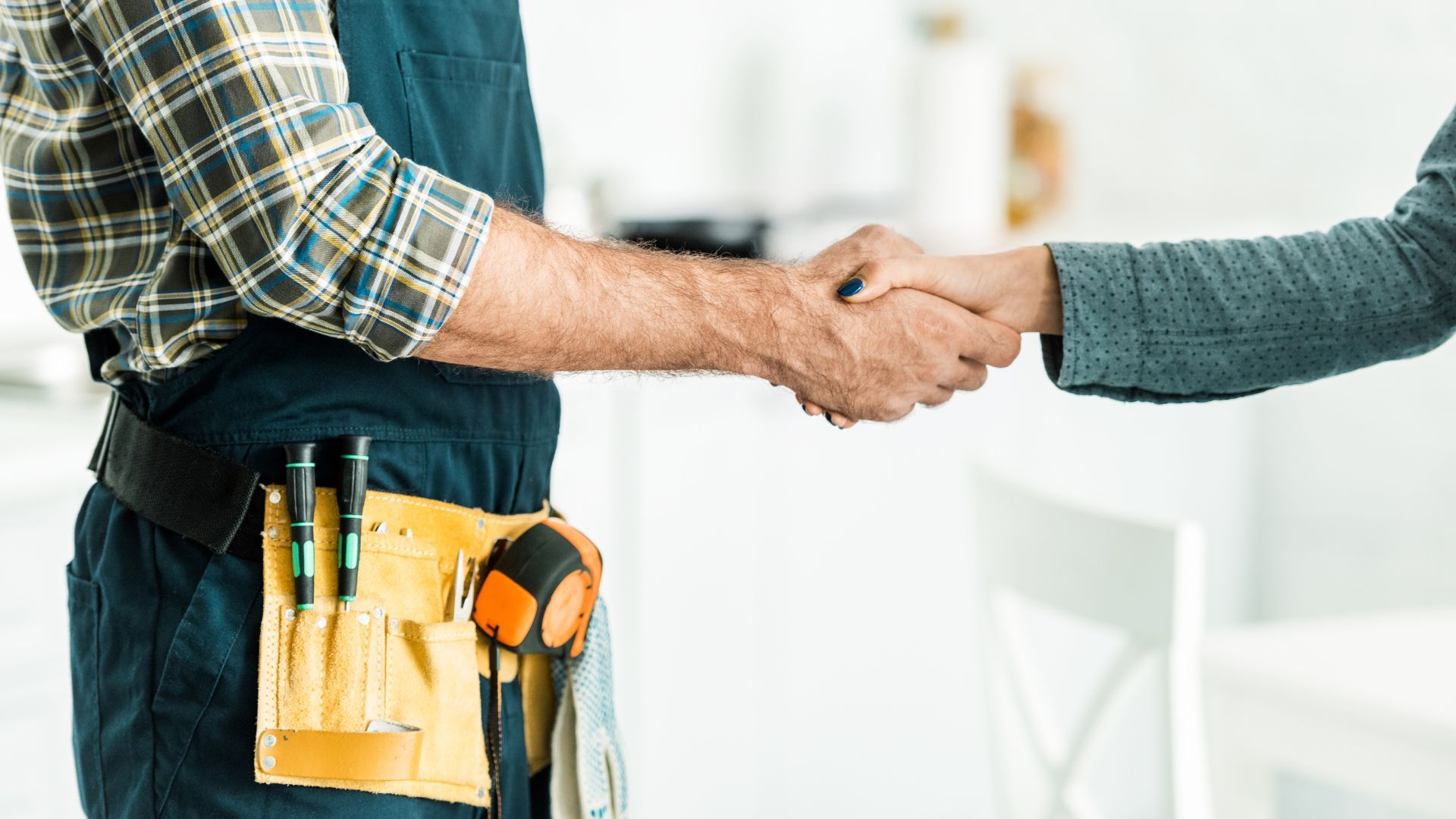 Plumber shaking hands with customer