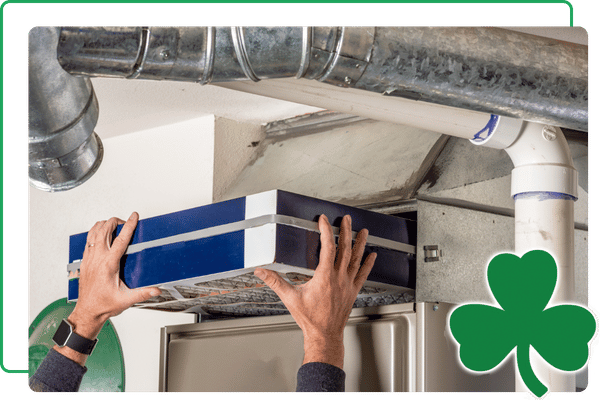 technician replacing furnace filter