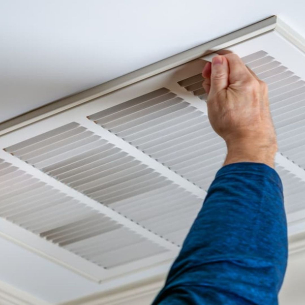 HVAC tech checking air system intakes HVAC tech checking air system intakes