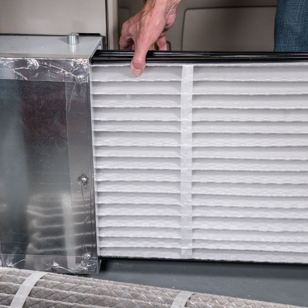 HVAC tech changing furnace filter HVAC tech changing furnace filter