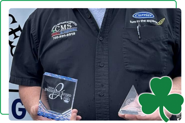 Carroll employee holding awards