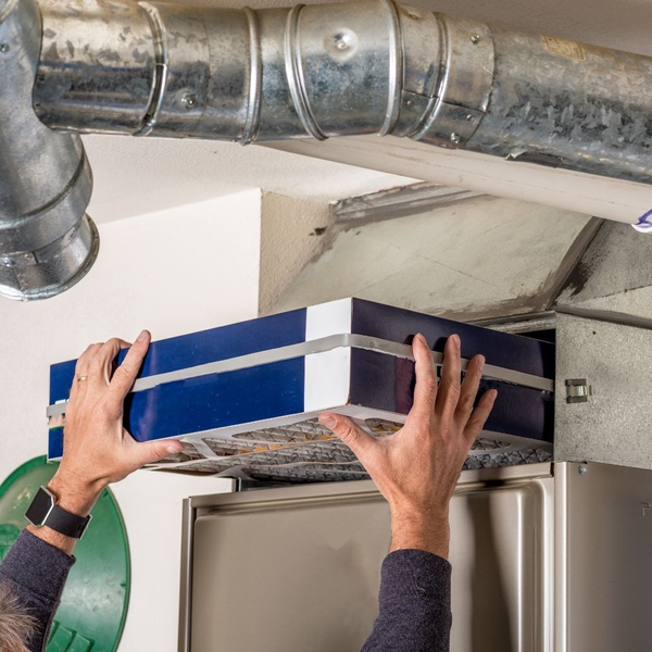 hand changing an air filter