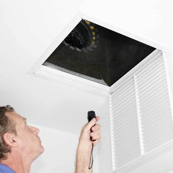 technician inspecting vent