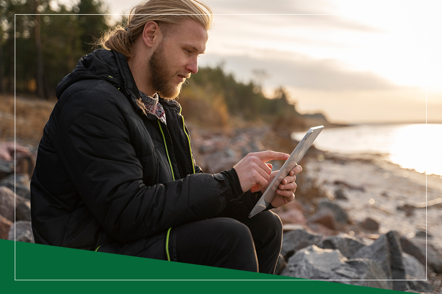 image of a man using an iPad outside