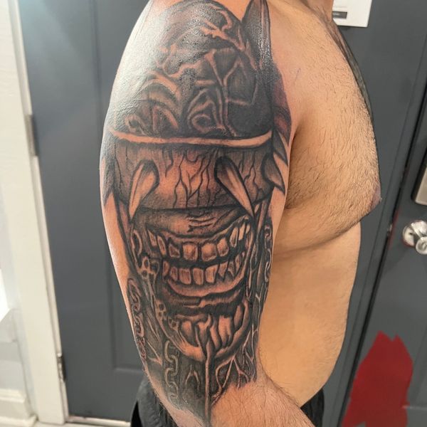 Shoulder tattoo of a creature
