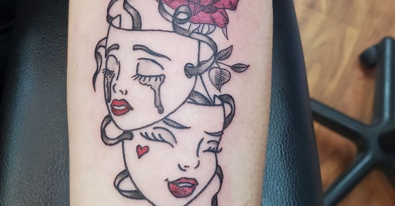 Tattoo of crying and smiling masks