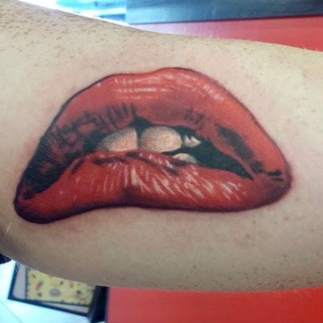 Photorealistic tattoo of biting a lip