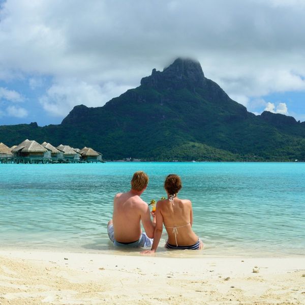 couple on vacation sitting on tropical beach couple on vacation sitting on tropical beach