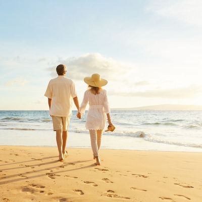 couple walking beach during vacation