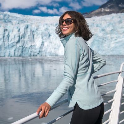 woman sightseeing glacier via boat near Alaska