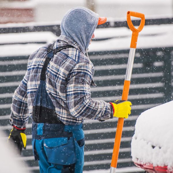 man holding snow shovel