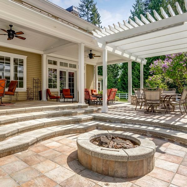 beautifully designed patio with stone firepit