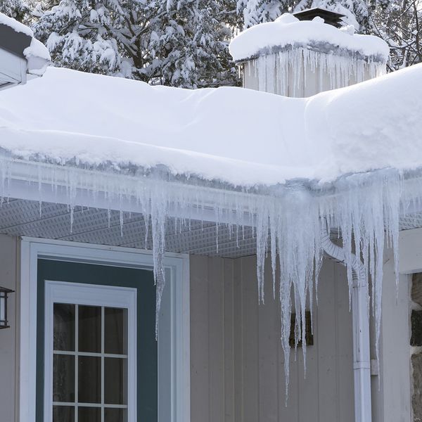 Image of a house with large ice sickles hanging from the gutters