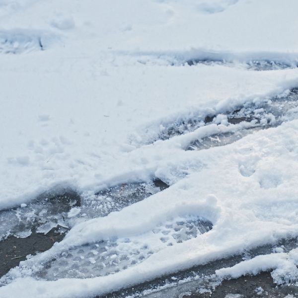 Footprints in snow on a sidewalk