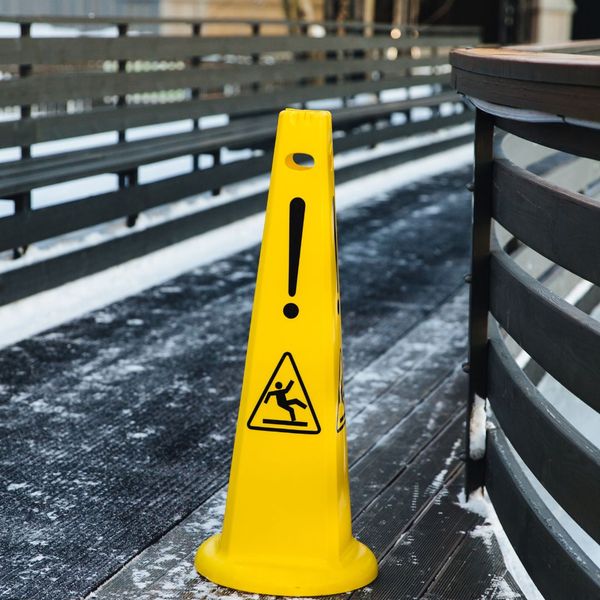 Slip warning cone sits on an icy pathway
