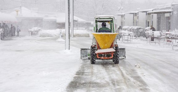 Person plowing a sidewalk