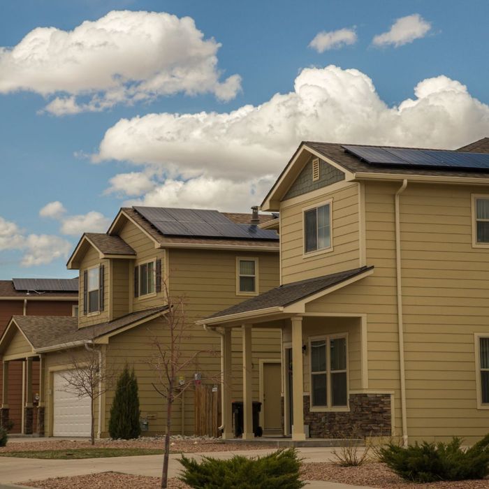 neighborhood with solar panels on home roofs