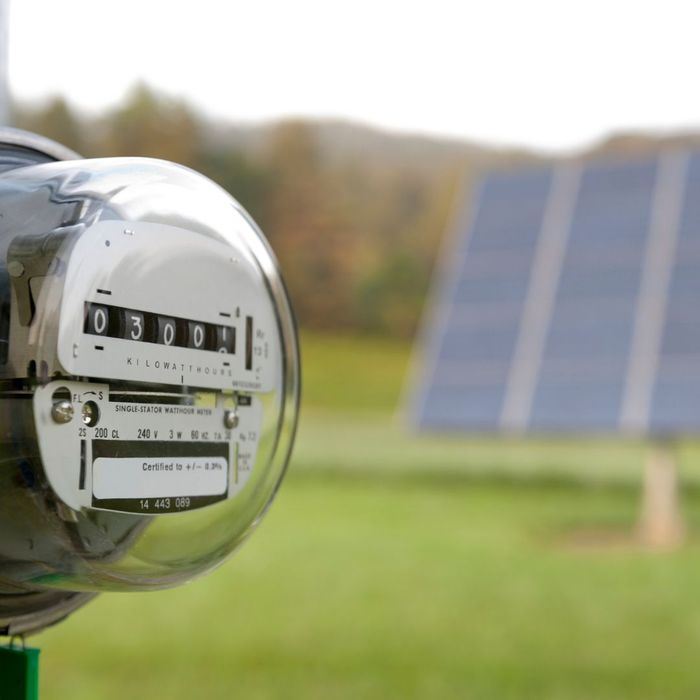 power meter in front of solar panel