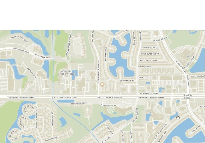 A light-colored map detailing the Sun City Center area, showcasing its characteristic circular street patterns, numerous water features, and the primary thoroughfare of Sun City Center Boulevard.