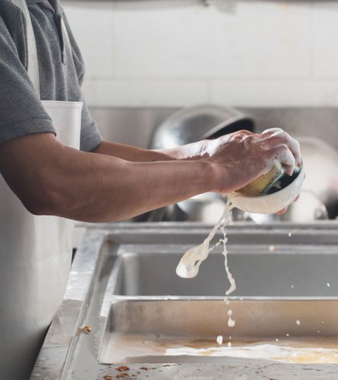 washing dishes in restaurant sink