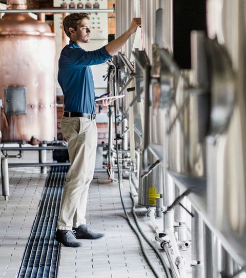 Brewer standing near floor drain in brewhouse