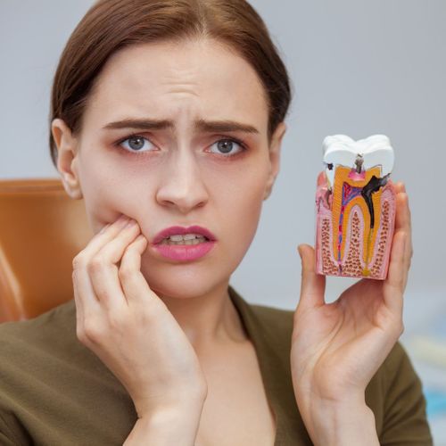 woman with cavity holding model of cavity