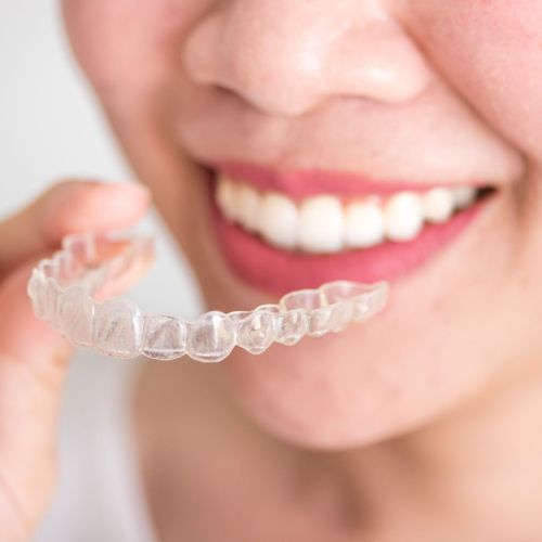 woman with invisalign tray