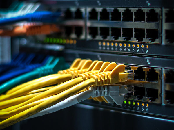 array of colorful computer cables plugging into computer tower