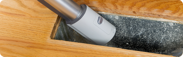 vacuuming out floor vent