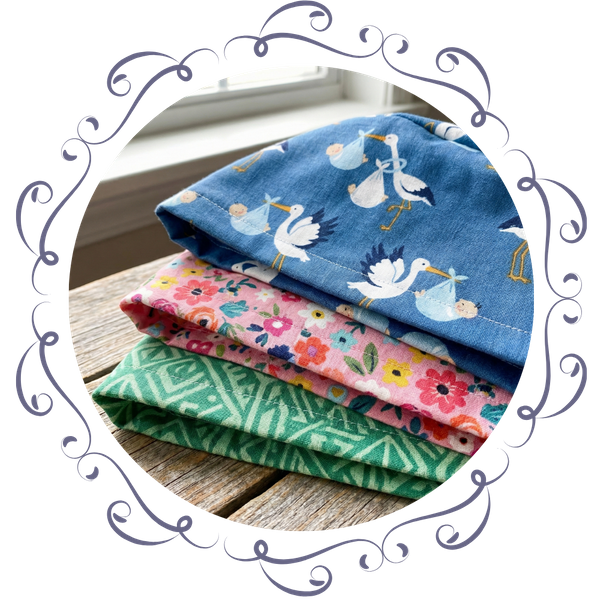 A close-up view of three folded scrub caps showing different stylish patterns and colors.