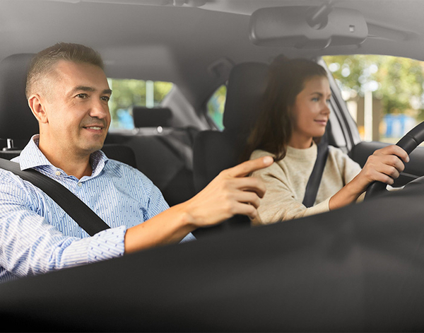 Male driving instructor with female student