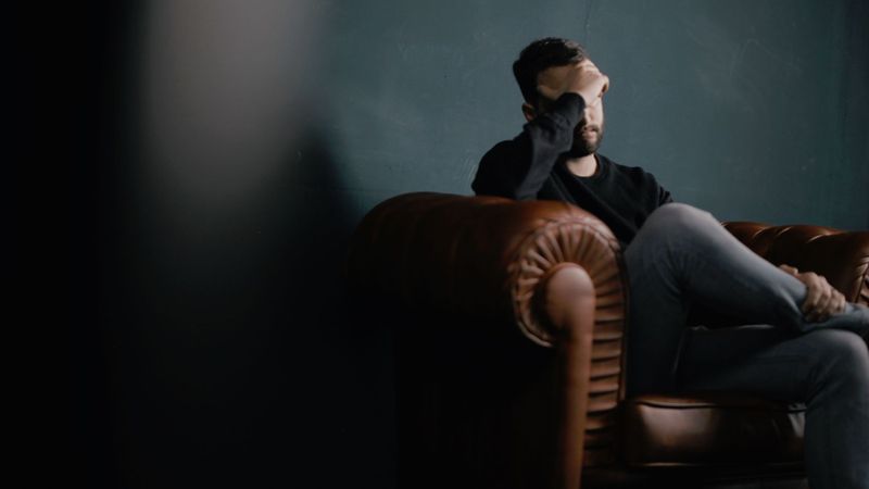 man upset sitting in chair