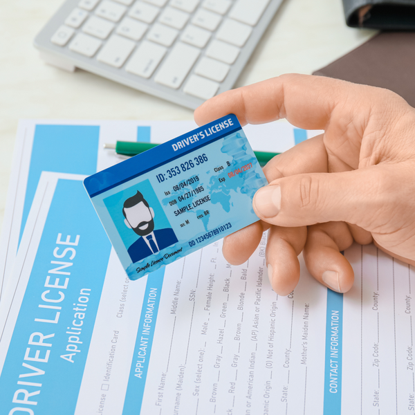 person examining a driver's license.