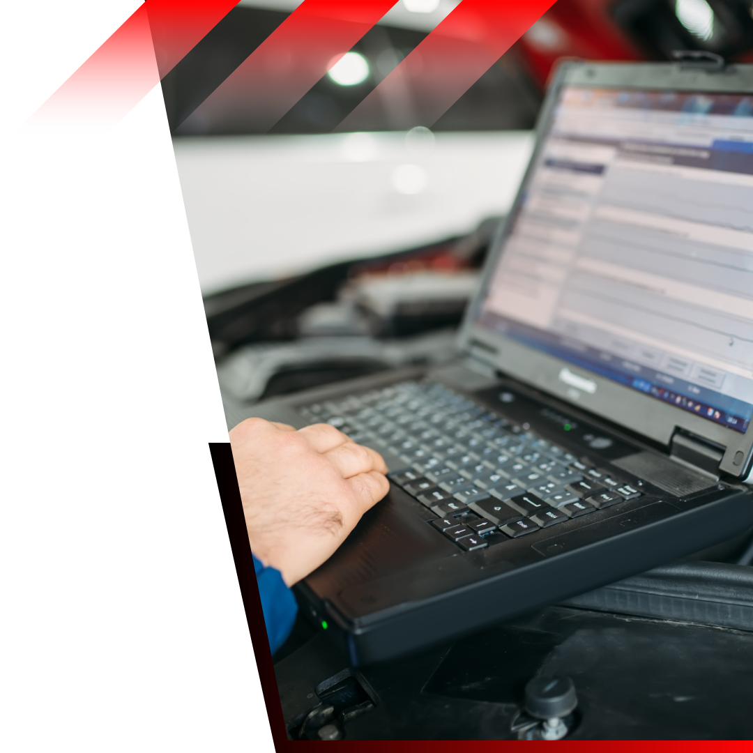 mechanic looking at codes in a computer 