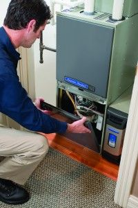 Image of a man working on a heater