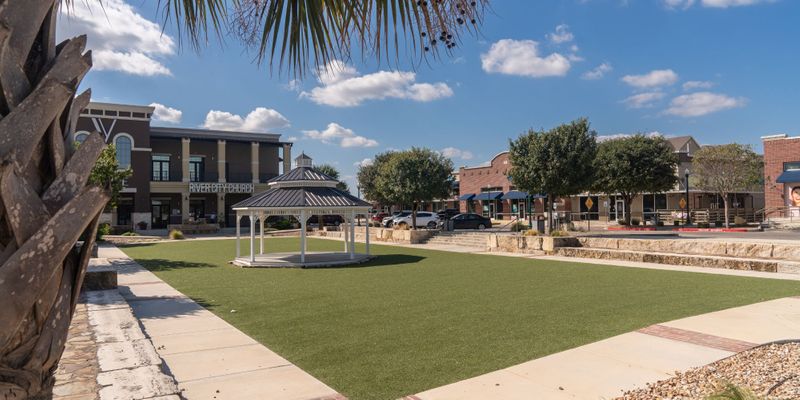 gazebo in park, surrounded by rows of shops