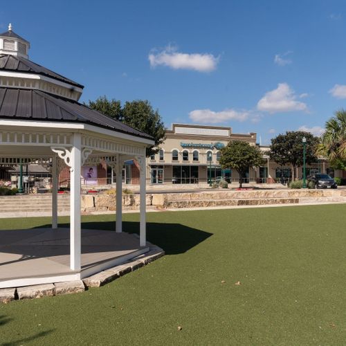 green space with shops in background