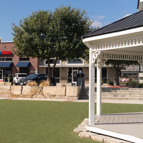 gazebo in park, surrounded by rows of shops