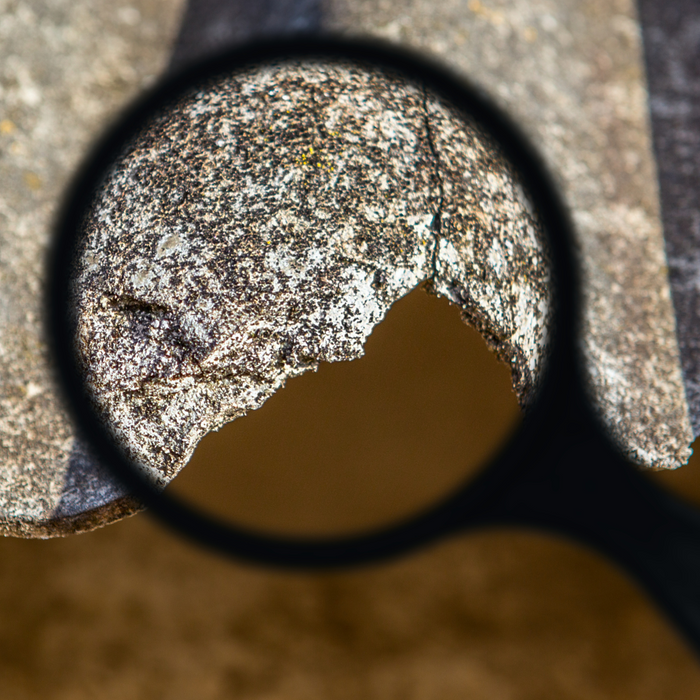 A magnifying glass showing a close up of metal