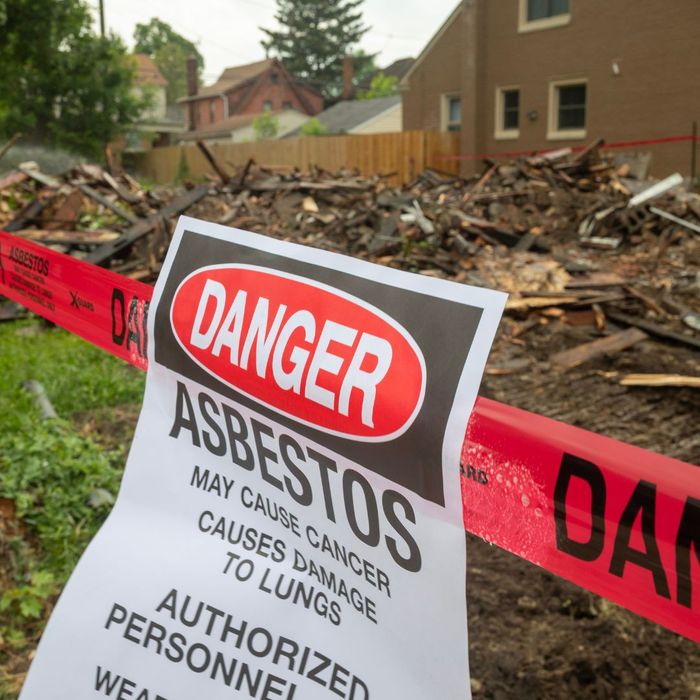 red caution tape with the word 'danger' on it, with a sign taped to it that says 'danger asbestos" red caution tape with the word 'danger' on it, with a sign taped to it that says 'danger asbestos"