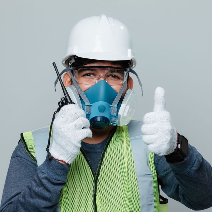 a man giving thumbs up in a mask and hard hat a man giving thumbs up in a mask and hard hat