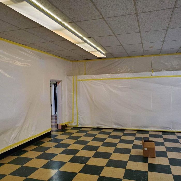 a room with checkered tile that is lined with plastic during an asbestos cleanup a room with checkered tile that is lined with plastic during an asbestos cleanup