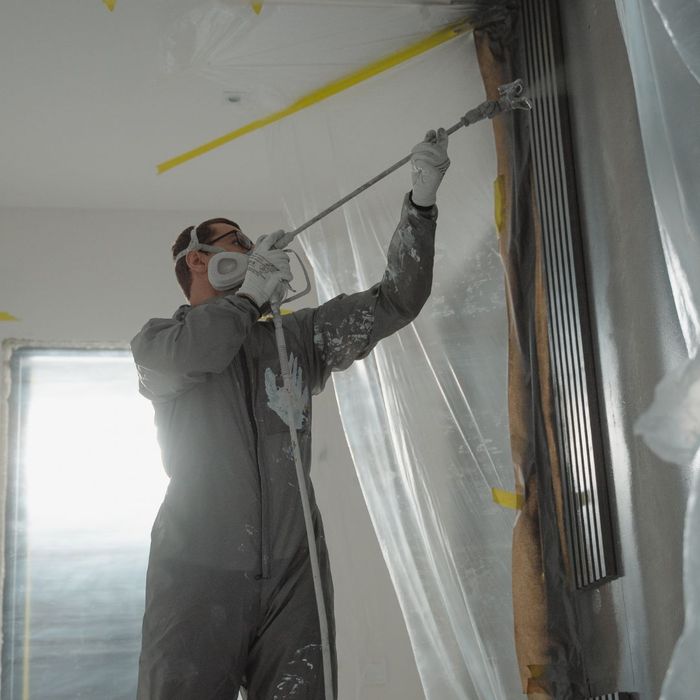 a man painting over a removal of asbestos a man painting over a removal of asbestos