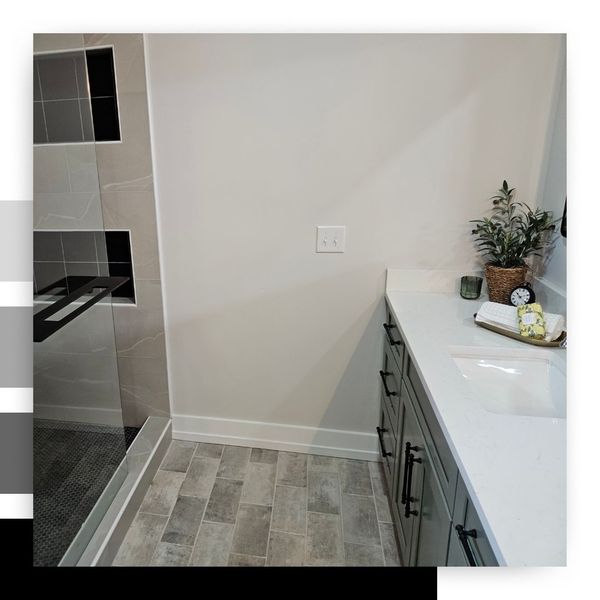 Modern bathroom vanity with a light gray cabinet, white countertop, and under-mount sink