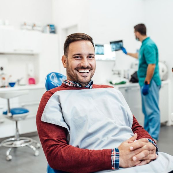 Smiling patient in dentist's chair