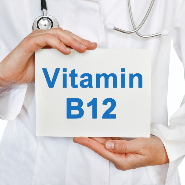 doctor holding piece of paper with "Vitamin B12"