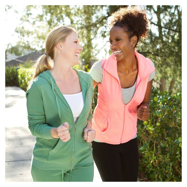 two women laughing while on a walk