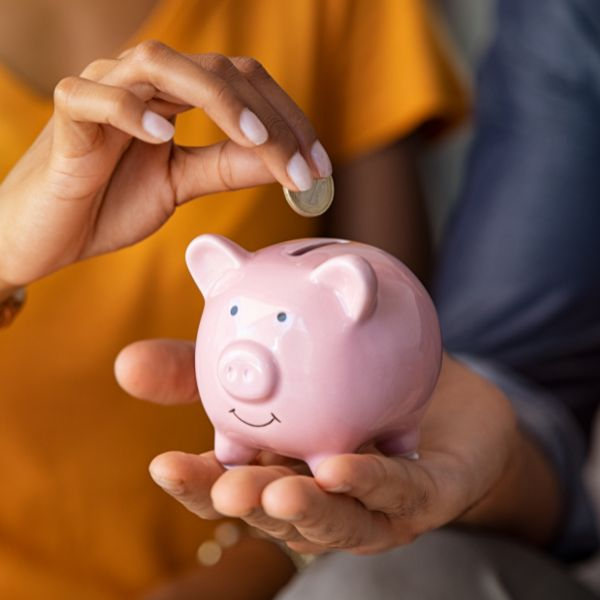adding money to a piggy bank