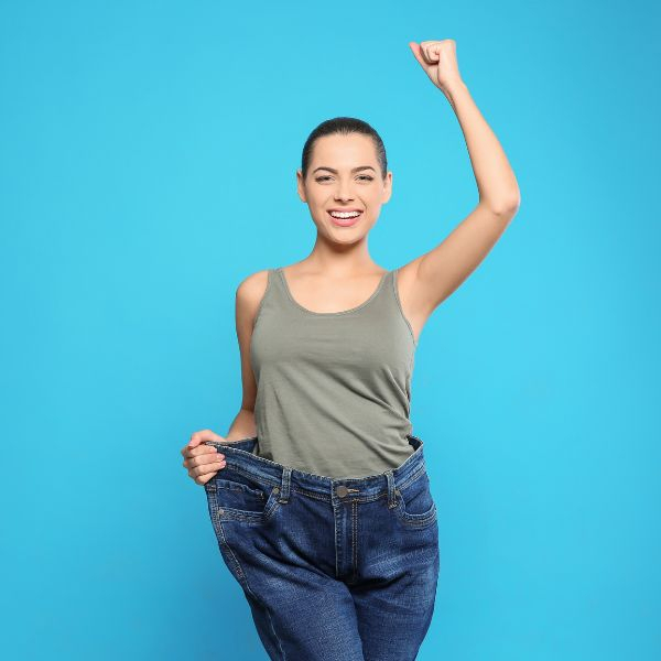 woman looking triumphant in jeans with a baggy waist