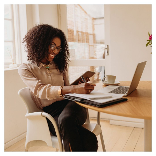 woman working on tablet and laptop